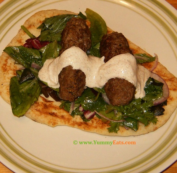 Lamb Kofta with Herb Salad over Charred Naan - recipe cooked and plated.