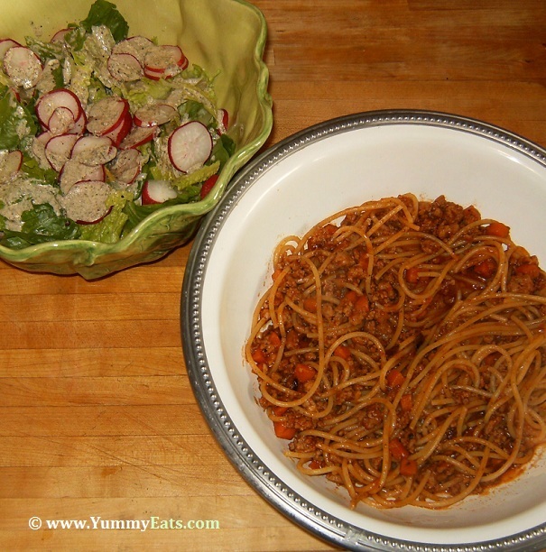 Spaghetti Bolognese and Green Salad topped with Radishes, prepared using ingredients and recipes from Blue Apron.