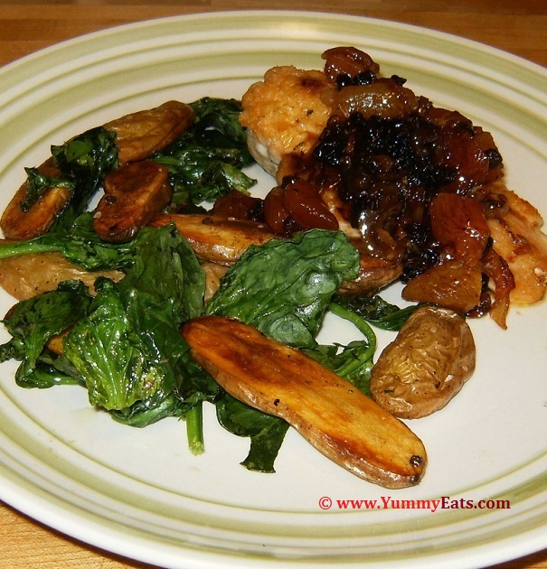 Braised Chicken, Apricots, and Currants with Roasted Fingerling Potatoes, Spinach and a sweet White Wine Sauce. Plated recipe.