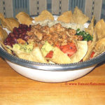 Taco Salad Bowl loaded up with Tortilla Chips and assorted toppings.